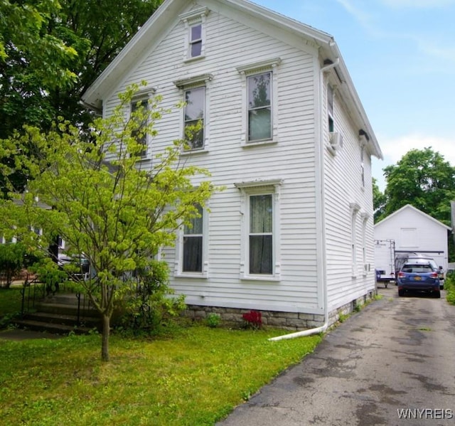 57 Christiana St, North Tonawanda, NY 14120 - view of home's exterior with a detached garage, a yard, and an outdoor structure