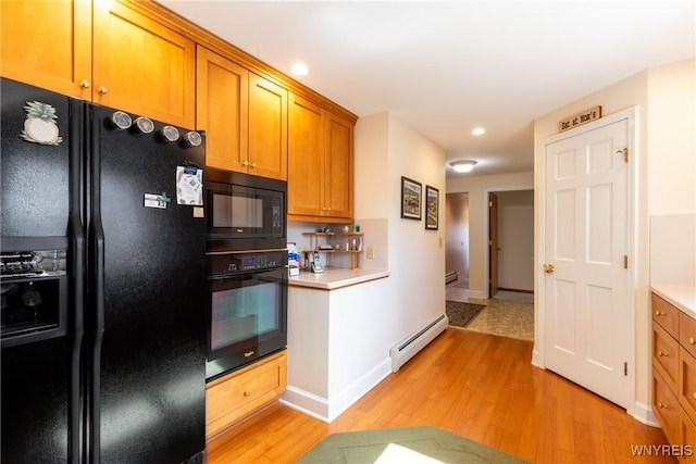 288 W Maplemere Rd, Amherst, NY 14221 - kitchen with black appliances, a baseboard radiator, light wood-type flooring, light countertops, and recessed lighting