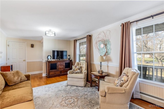 288 W Maplemere Rd, Amherst, NY 14221 - living area with a baseboard radiator, wood finished floors, ornamental molding, and wainscoting