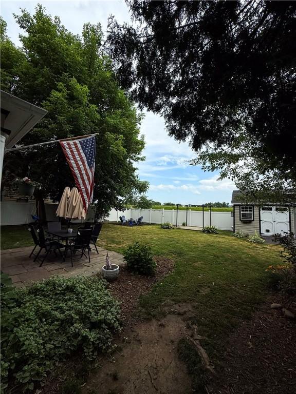 459 W Water St, Elmira City, NY 14905 - fenced backyard featuring a patio area and an outbuilding