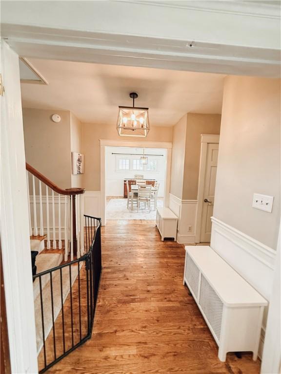 459 W Water St, Elmira City, NY 14905 - hall with light wood-style floors, a wainscoted wall, stairway, and a decorative wall