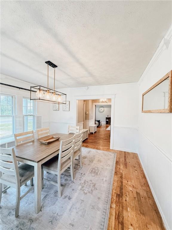 459 W Water St, Elmira City, NY 14905 - dining space featuring a textured ceiling, light wood-style floors, and a chandelier