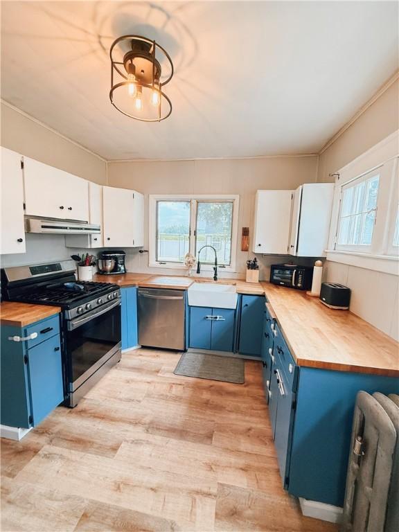 459 W Water St, Elmira City, NY 14905 - kitchen with stainless steel appliances, blue cabinets, wood counters, light wood-style flooring, and white cabinets