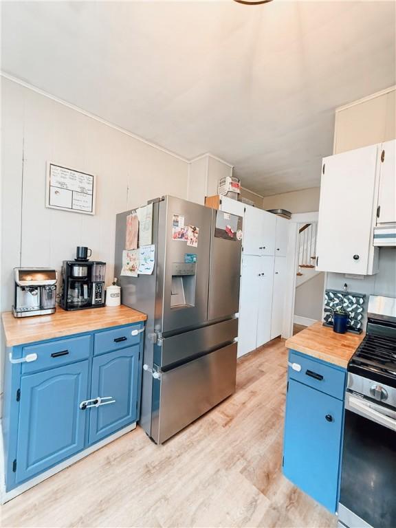 459 W Water St, Elmira City, NY 14905 - kitchen with appliances with stainless steel finishes, blue cabinetry, light wood-style flooring, and butcher block counters