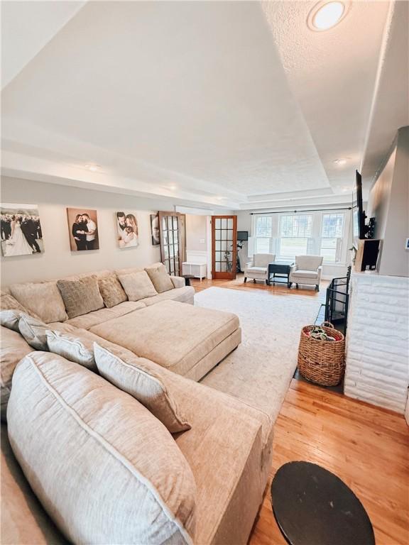 459 W Water St, Elmira City, NY 14905 - living room featuring wood finished floors, a raised ceiling, and recessed lighting