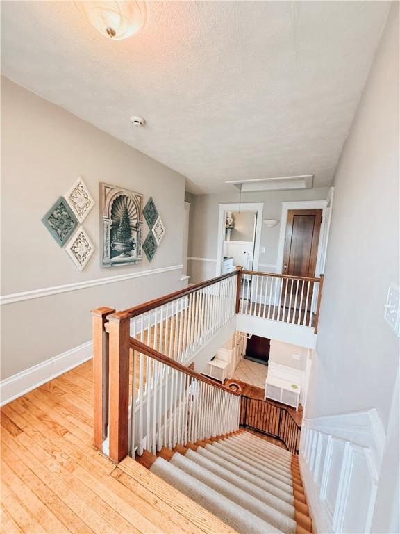 459 W Water St, Elmira City, NY 14905 - stairs featuring attic access and wood finished floors