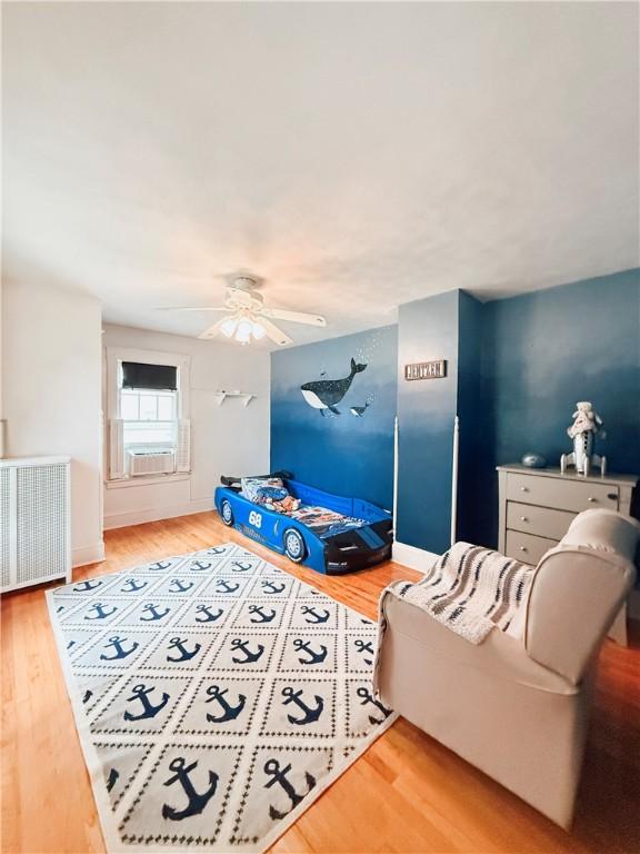 459 W Water St, Elmira City, NY 14905 - living room with radiator heating unit, wood finished floors, and ceiling fan