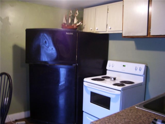 30 Mitchell St, Norwich, NY 13815 - kitchen featuring electric stove, freestanding refrigerator, white cabinets, and dark countertops