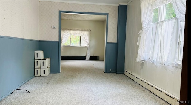 350 S 2nd St, Lewiston, NY 14092 - carpeted empty room with a baseboard heating unit, a wainscoted wall, wallpapered walls, and crown molding