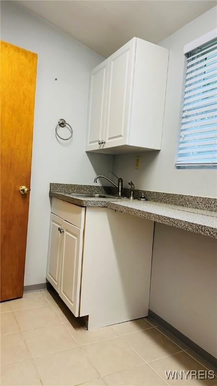 350 S 2nd St, Lewiston, NY 14092 - kitchen featuring white cabinetry, light tile patterned flooring, and dark countertops