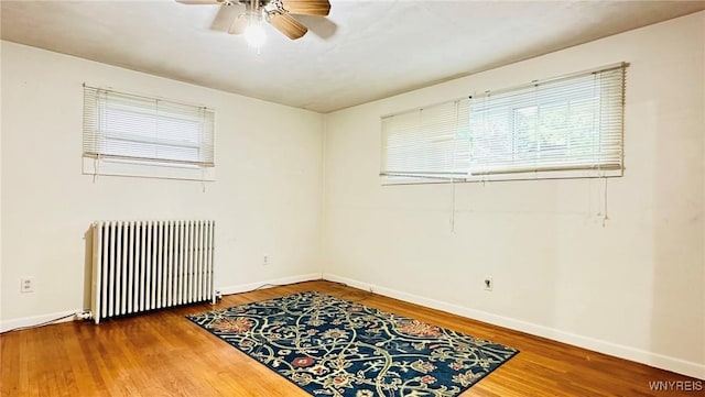 350 S 2nd St, Lewiston, NY 14092 - spare room with radiator heating unit, ceiling fan, wood finished floors, and healthy amount of natural light