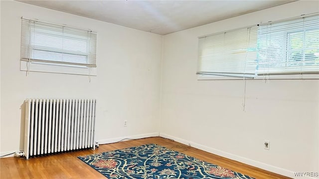 350 S 2nd St, Lewiston, NY 14092 - unfurnished room with radiator heating unit, healthy amount of natural light, and wood finished floors