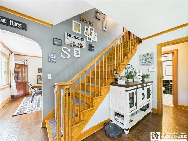 709 Main St, Olean, NY 14760 - staircase featuring hardwood / wood-style flooring and arched walkways