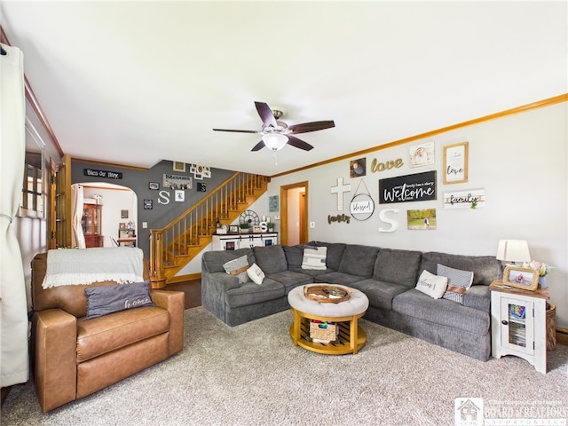 709 Main St, Olean, NY 14760 - carpeted living room featuring stairs, arched walkways, ceiling fan, and ornamental molding