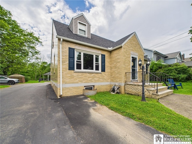 709 Main St, Olean, NY 14760 - view of front of home with brick siding, a shingled roof, and a front lawn
