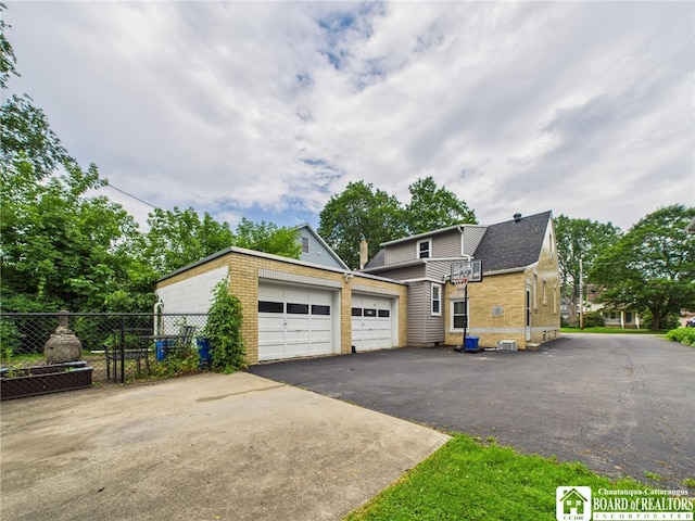709 Main St, Olean, NY 14760 - view of front facade with brick siding, driveway, and a garage