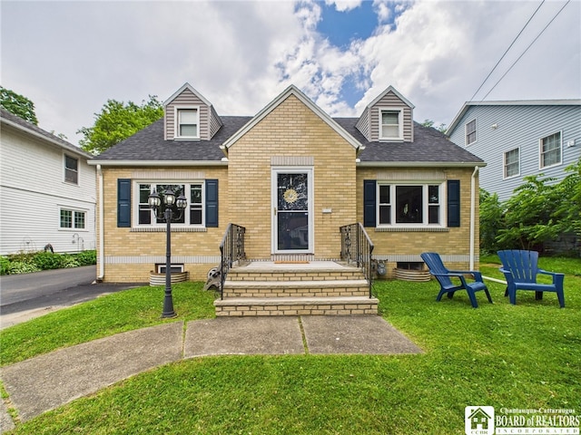 709 Main St, Olean, NY 14760 - cape cod home featuring brick siding, a front lawn, and roof with shingles