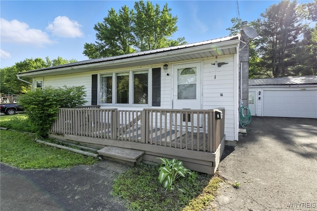 11583 Gowanda State Rd, North Collins, NY 14111 - ranch-style home with a metal roof, a garage, a wooden deck, and a chimney