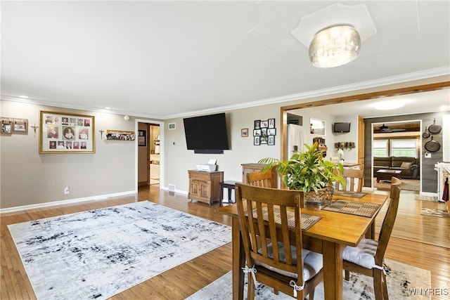 11583 Gowanda State Rd, North Collins, NY 14111 - dining space featuring crown molding and light wood finished floors