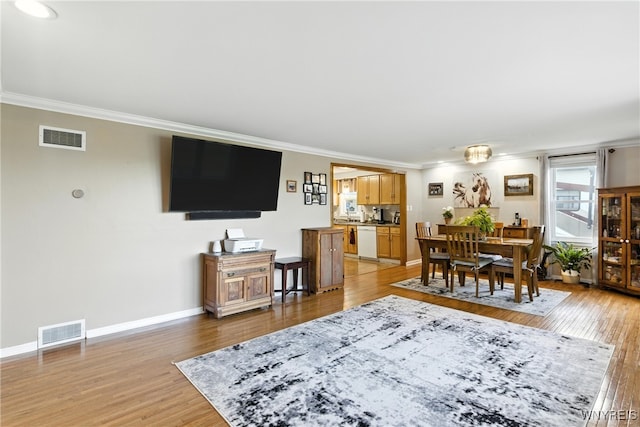 11583 Gowanda State Rd, North Collins, NY 14111 - dining area with ornamental molding and light wood-style floors
