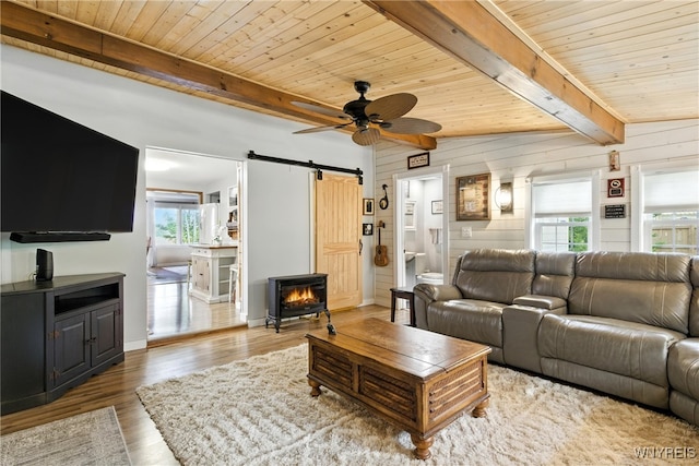 11583 Gowanda State Rd, North Collins, NY 14111 - living area with a barn door, a wood ceiling with exposed beams, ceiling fan, wood finished floors, and wooden walls