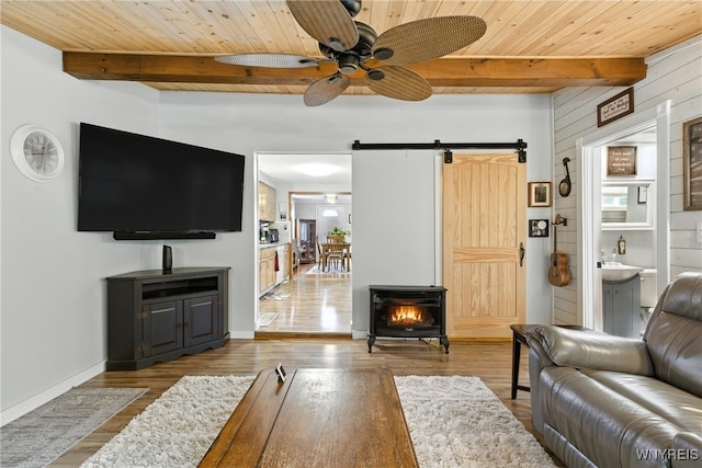 11583 Gowanda State Rd, North Collins, NY 14111 - living room with a wooden ceiling with exposed beams, a barn door, ceiling fan, and wood finished floors