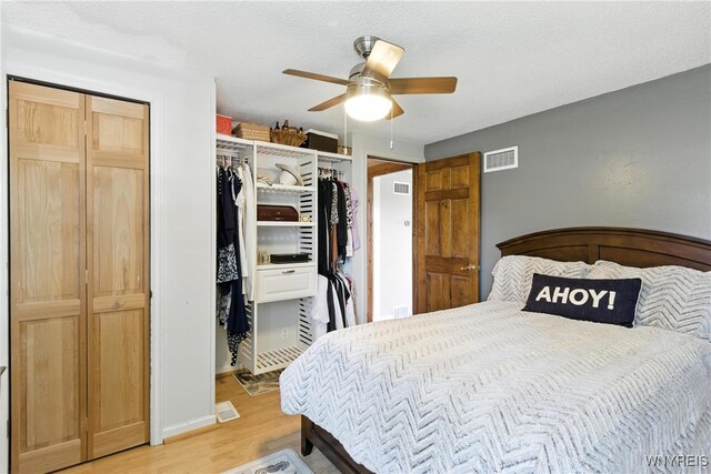 11583 Gowanda State Rd, North Collins, NY 14111 - bedroom with light wood-style floors, a ceiling fan, and a textured ceiling