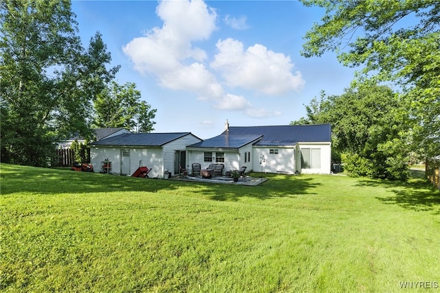 11583 Gowanda State Rd, North Collins, NY 14111 - rear view of property featuring a lawn, a patio area, and a metal roof