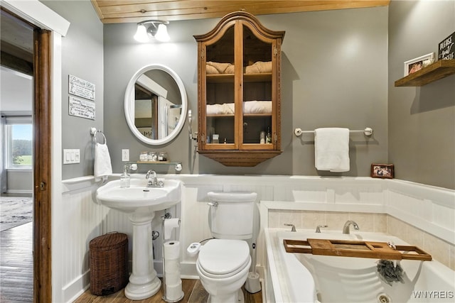 11583 Gowanda State Rd, North Collins, NY 14111 - bathroom featuring wood finished floors, wainscoting, and a whirlpool tub