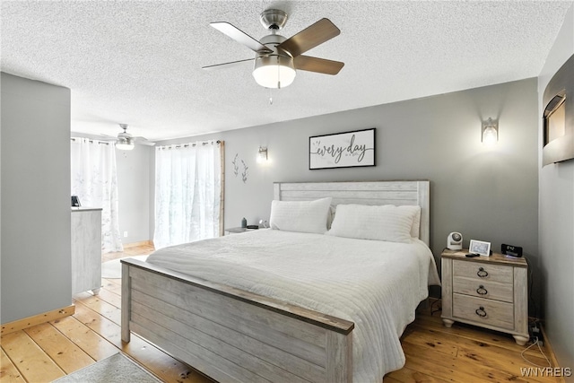 11583 Gowanda State Rd, North Collins, NY 14111 - bedroom with light wood-style flooring, a textured ceiling, and a ceiling fan