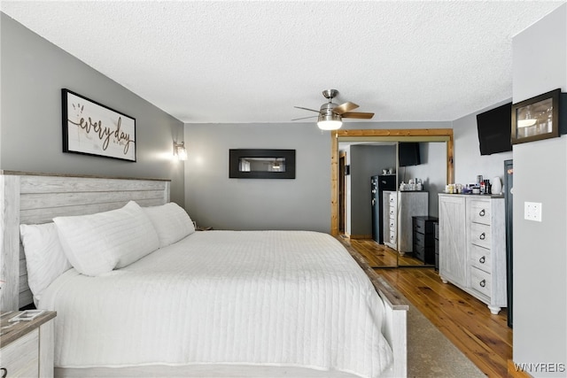 11583 Gowanda State Rd, North Collins, NY 14111 - bedroom with wood finished floors, a textured ceiling, and a ceiling fan