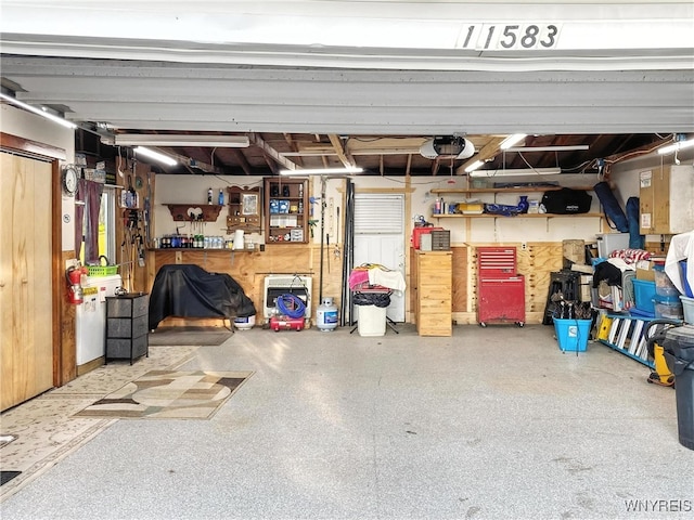 11583 Gowanda State Rd, North Collins, NY 14111 - garage with a workshop area and a garage door opener