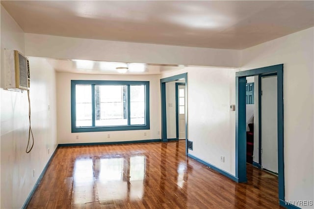 807 Tifft St, Buffalo, NY 14220 - empty room featuring wood finished floors and an AC wall unit