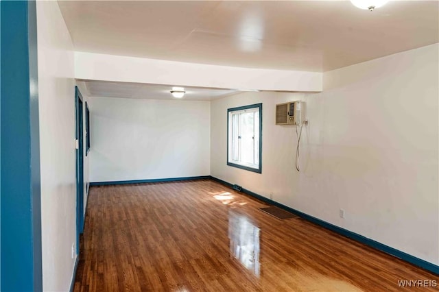 807 Tifft St, Buffalo, NY 14220 - unfurnished room with a wall mounted air conditioner and wood finished floors