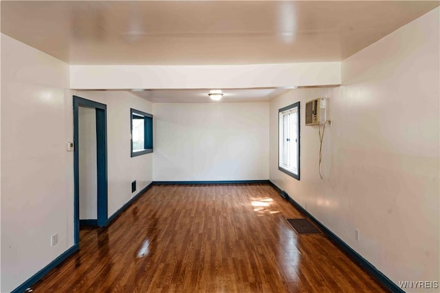 807 Tifft St, Buffalo, NY 14220 - empty room with an AC wall unit and wood finished floors