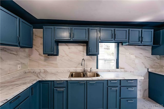 807 Tifft St, Buffalo, NY 14220 - kitchen featuring blue cabinetry, light countertops, and decorative backsplash