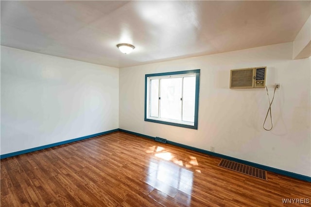 807 Tifft St, Buffalo, NY 14220 - empty room featuring a wall unit AC and wood finished floors