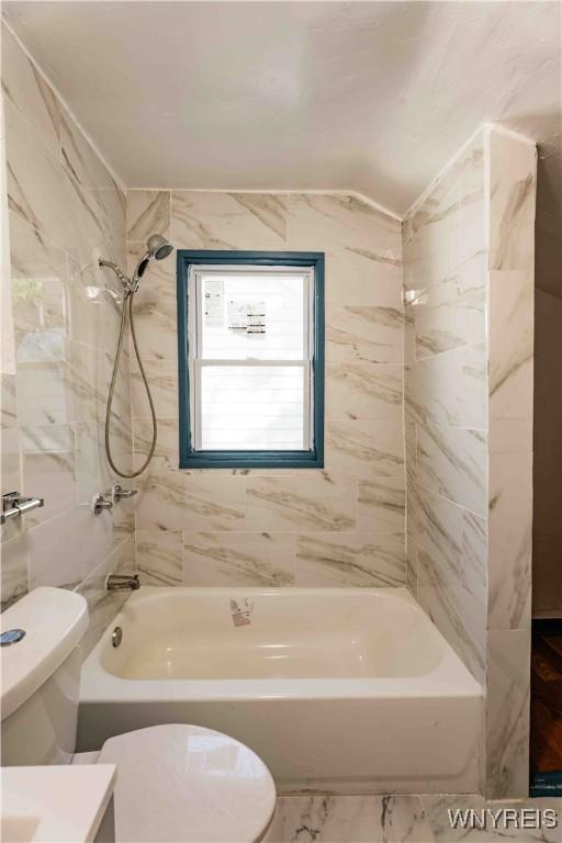 807 Tifft St, Buffalo, NY 14220 - full bath featuring  shower combination, vanity, vaulted ceiling, and marble finish flooring