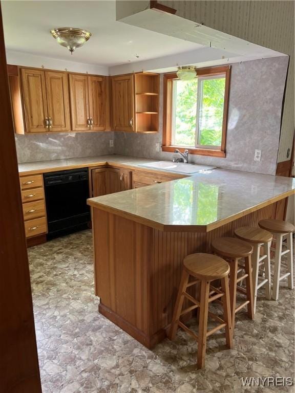 4535 Holley Byron Rd, Clarendon, NY 14470 - kitchen with black dishwasher, a peninsula, a kitchen bar, decorative backsplash, and light countertops