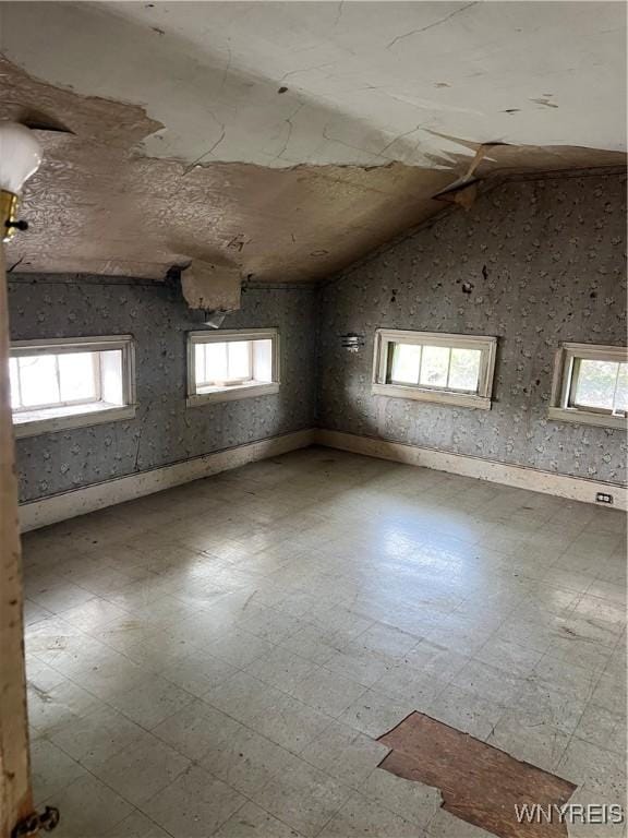 4535 Holley Byron Rd, Clarendon, NY 14470 - unfurnished room featuring healthy amount of natural light, tile patterned floors, and vaulted ceiling