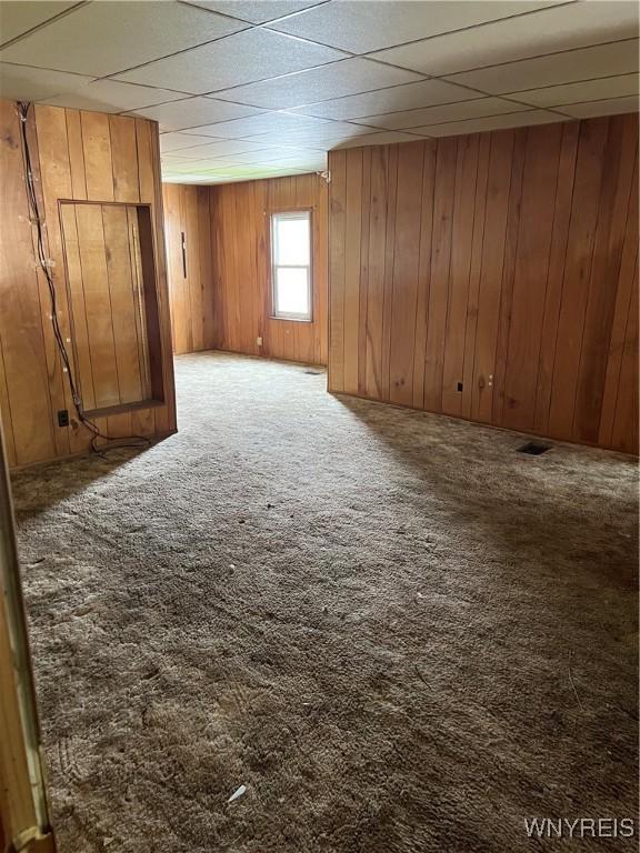 4535 Holley Byron Rd, Clarendon, NY 14470 - carpeted spare room with wood walls and a drop ceiling