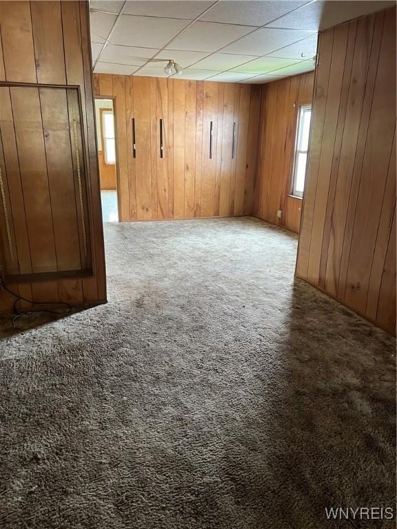 4535 Holley Byron Rd, Clarendon, NY 14470 - empty room with carpet floors, wood walls, and a drop ceiling