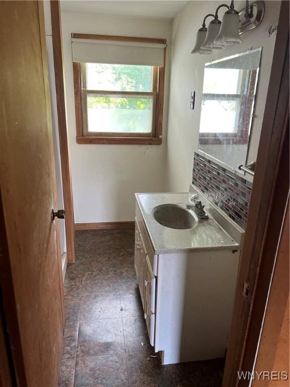 4535 Holley Byron Rd, Clarendon, NY 14470 - bathroom with vanity, decorative backsplash, and a chandelier