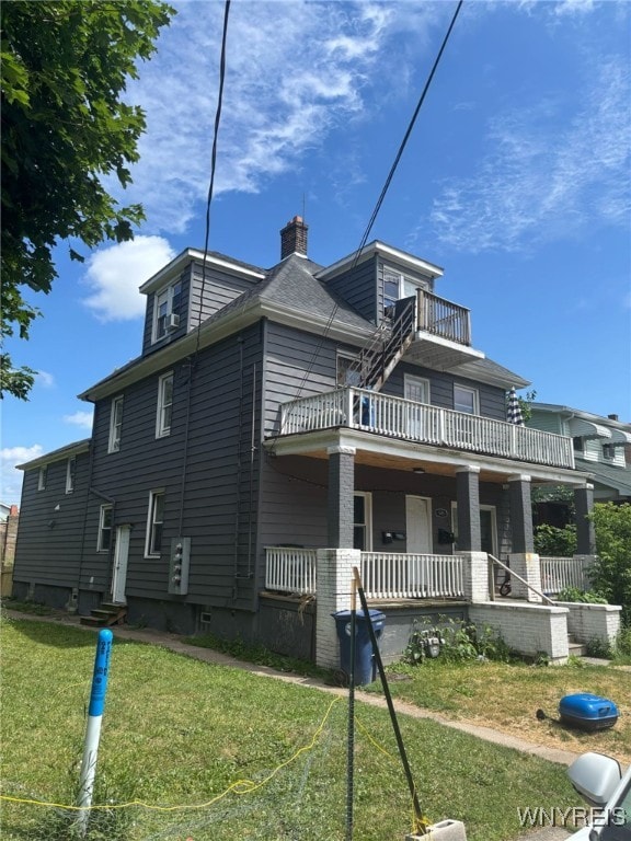 545 Tronolone Pl, Niagara Falls, NY 14301 - view of home's exterior with a balcony, a chimney, a lawn, and a porch