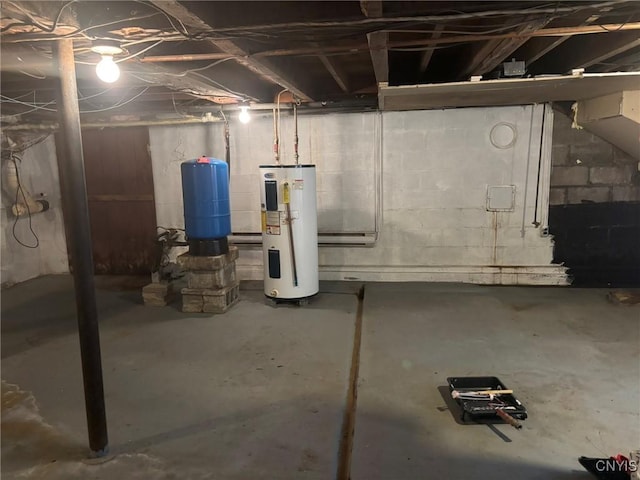 1046 Ammon Rd, Lewis, NY 13489 - unfinished below grade area with water heater, a water pressure tank, and a baseboard heating unit