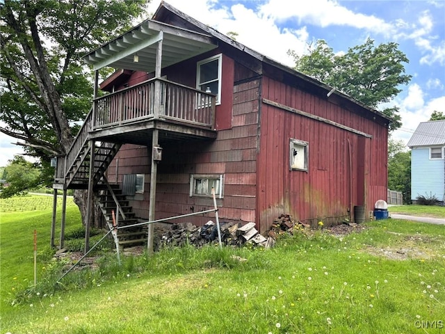 1046 Ammon Rd, Lewis, NY 13489 - view of side of property with stairway, a lawn, and a deck