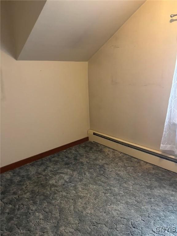 1046 Ammon Rd, Lewis, NY 13489 - bonus room with vaulted ceiling, carpet flooring, and a baseboard radiator
