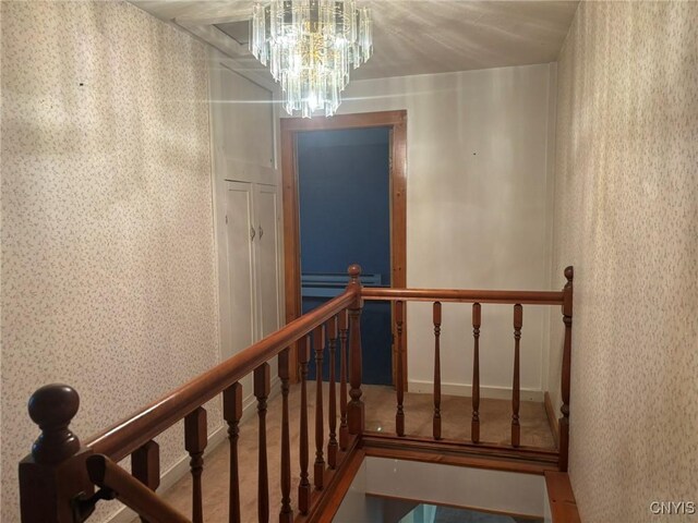 1046 Ammon Rd, Lewis, NY 13489 - stairway featuring wallpapered walls and a chandelier