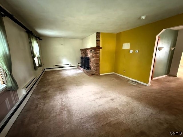1046 Ammon Rd, Lewis, NY 13489 - unfurnished living room with a fireplace, a baseboard radiator, arched walkways, and carpet