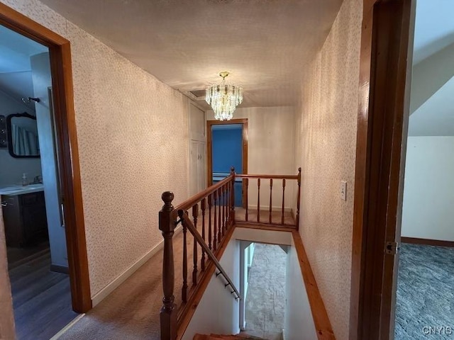 1046 Ammon Rd, Lewis, NY 13489 - stairs featuring a chandelier and carpet